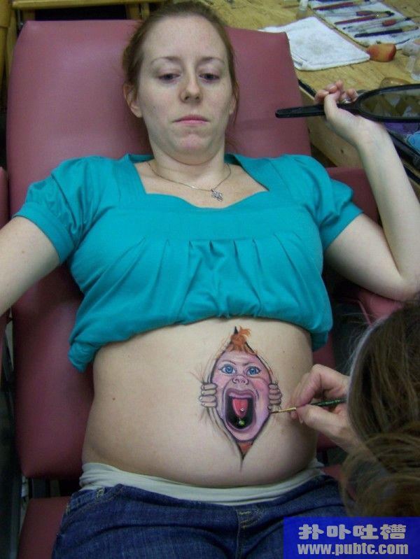 Belly painting being painted by an artist.
